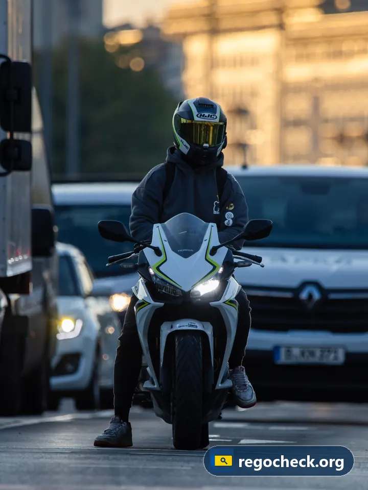 Deel van een motor 5 letters: motorrijder met helm tussen het verkeer in de stad